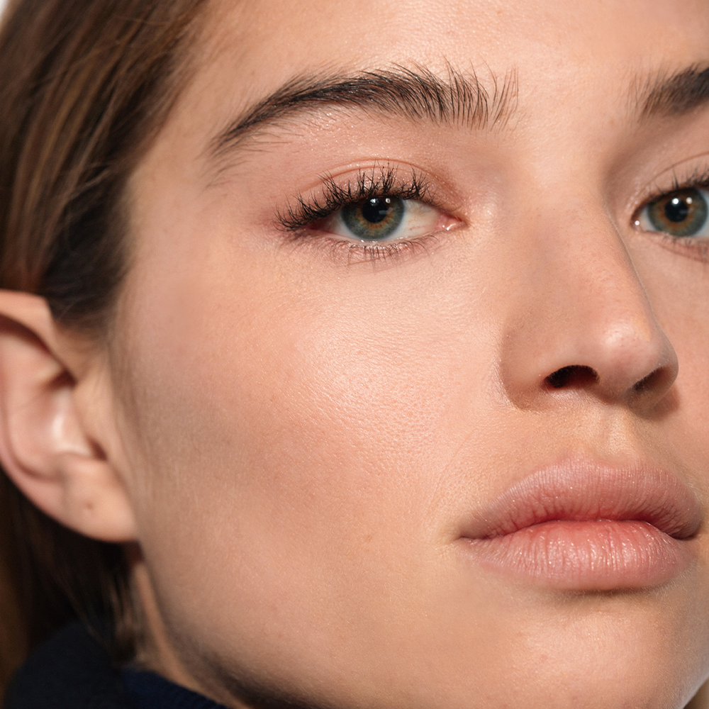 A close-up on a woman's face showing her "no makeup" makeup look using The 101 Set