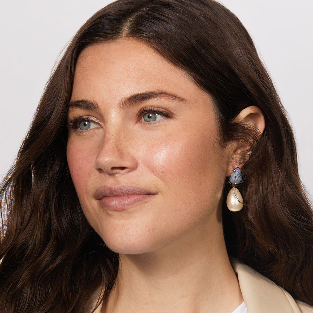 A woman wearing Jones Road Beauty's Shimmer Face Oil in Cool Rose
